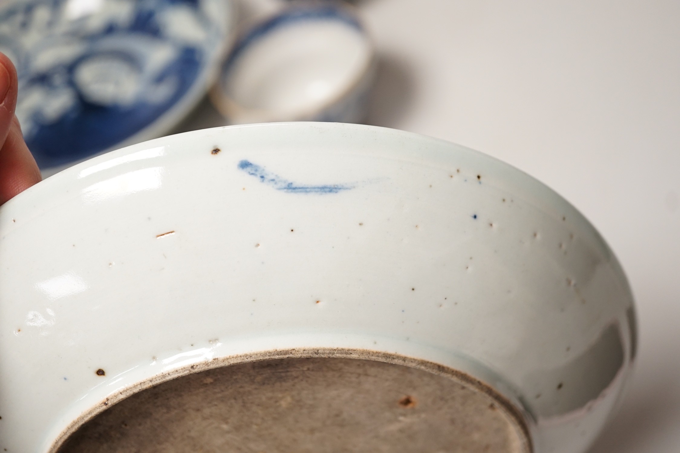 Two 19th century Chinese blue and white dishes and two 18th century tea bowls, largest 23cm diameter